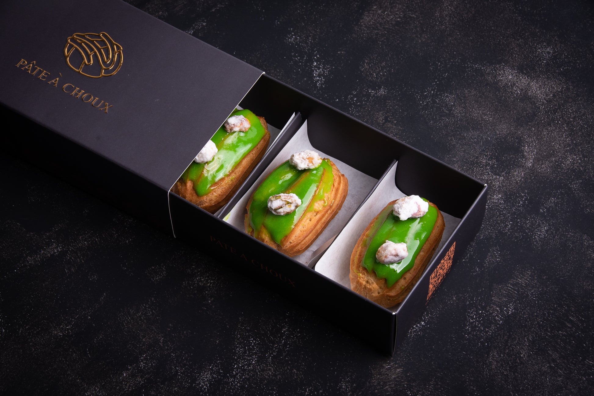 A small box of Pistachio Mini Eclairs