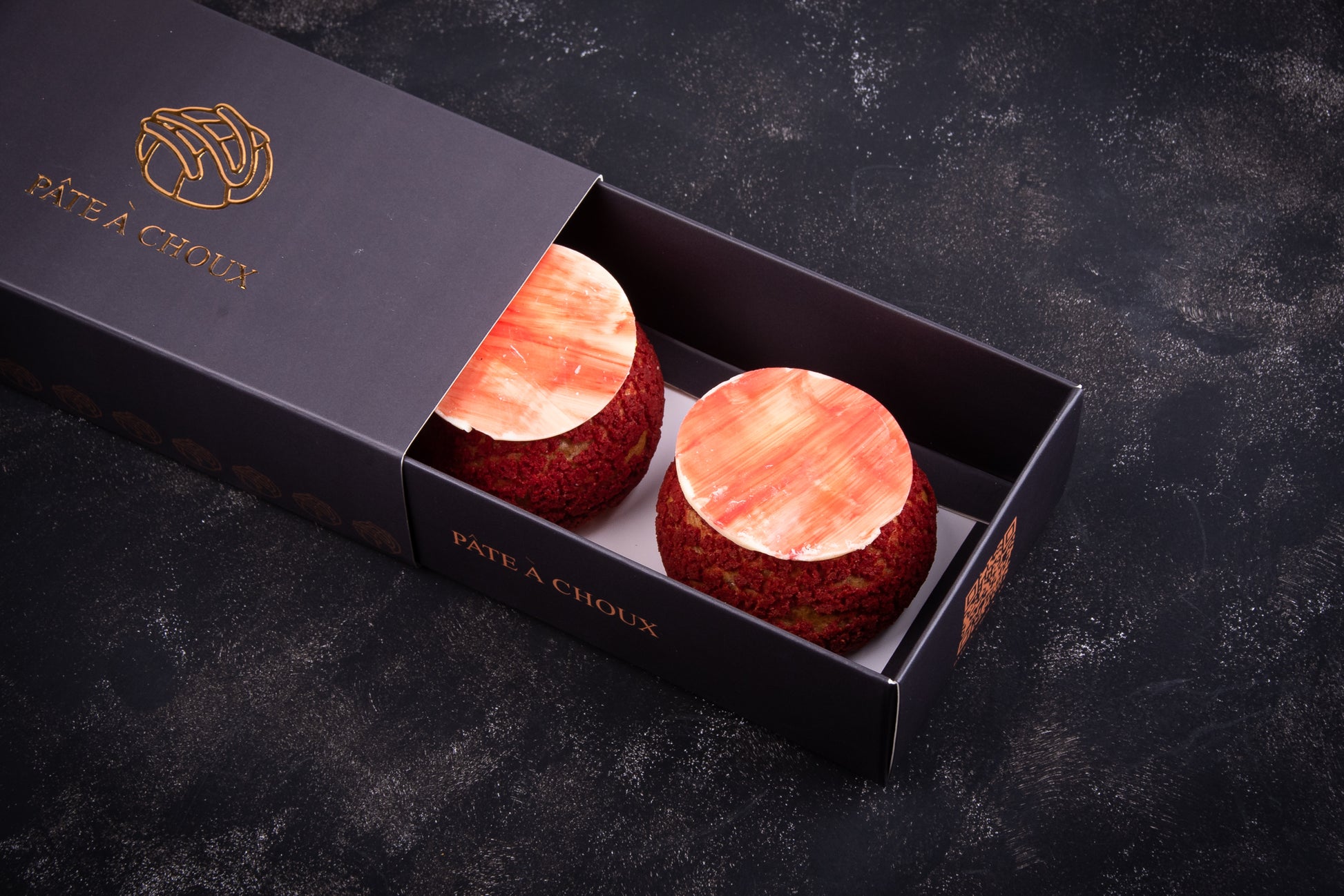 Strawberry Cheesecake Craquelin in a small box.