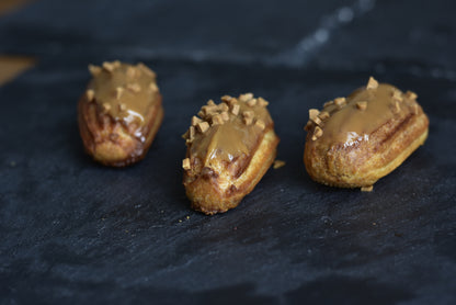 Salted caramel with glazed caramel topping, arranged on a black surface.